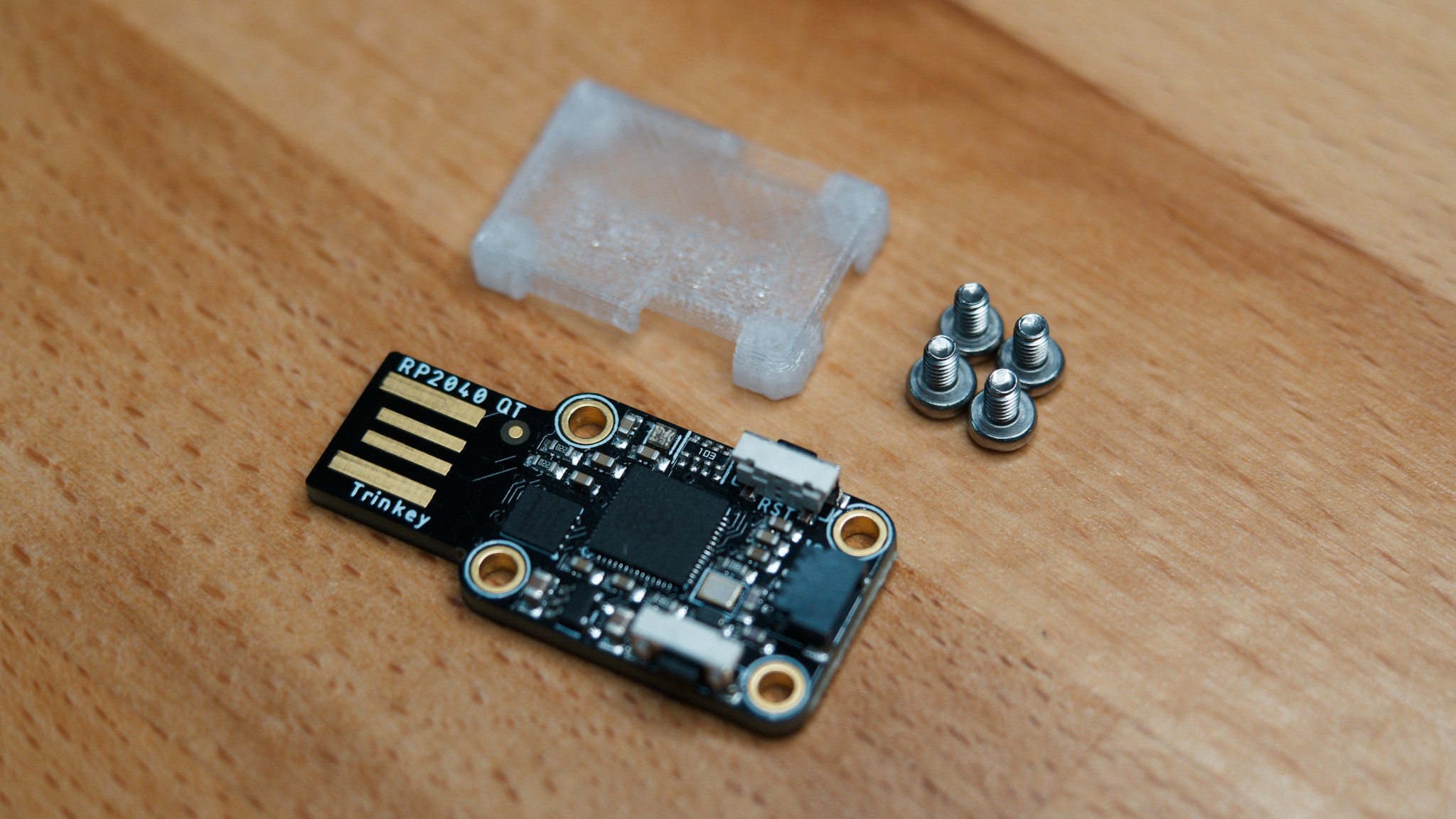 Adafruit Trinkey QT2040, 3D printed case, and screws