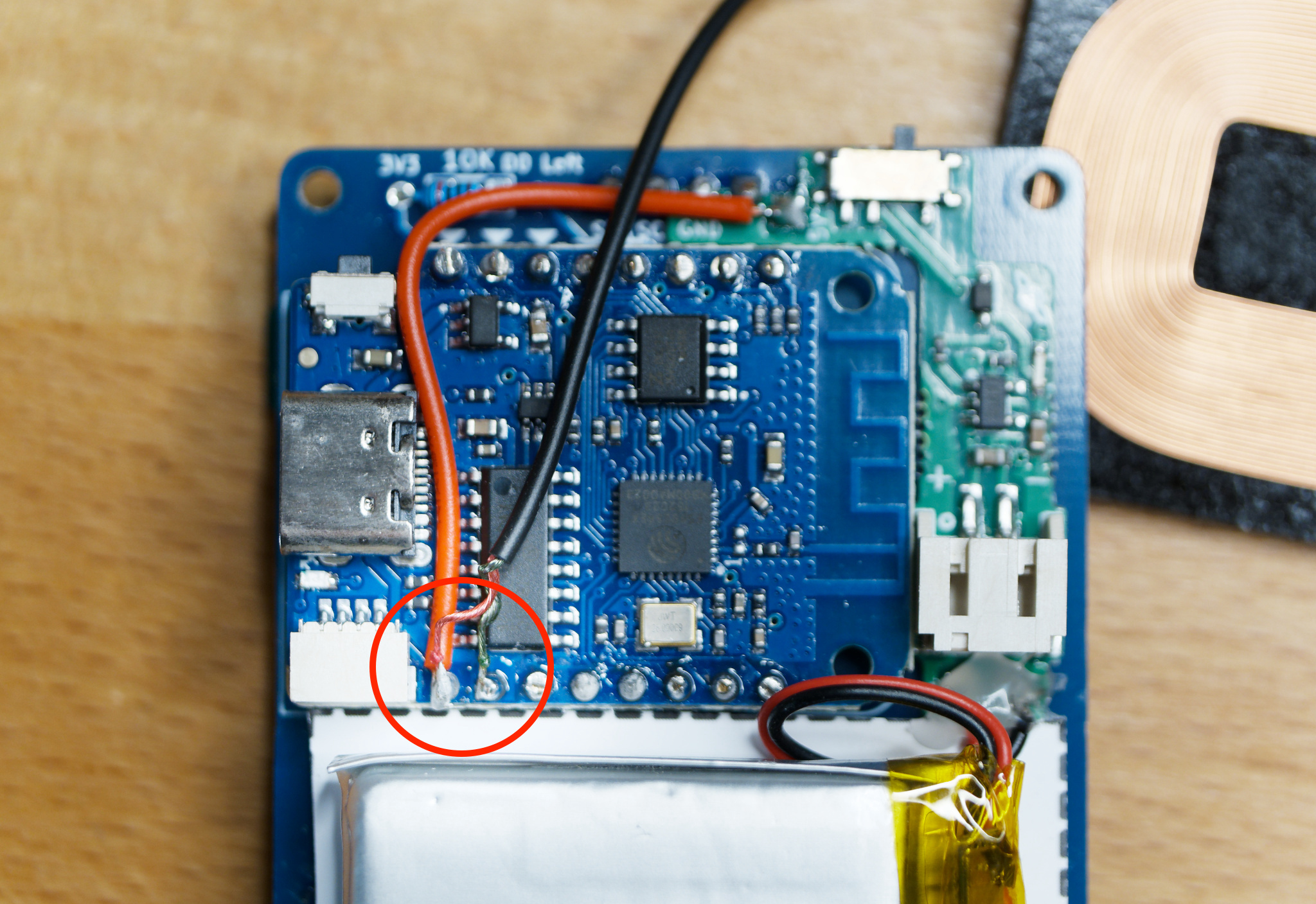 Back of HackHeld with soldered cables of wireless charging module