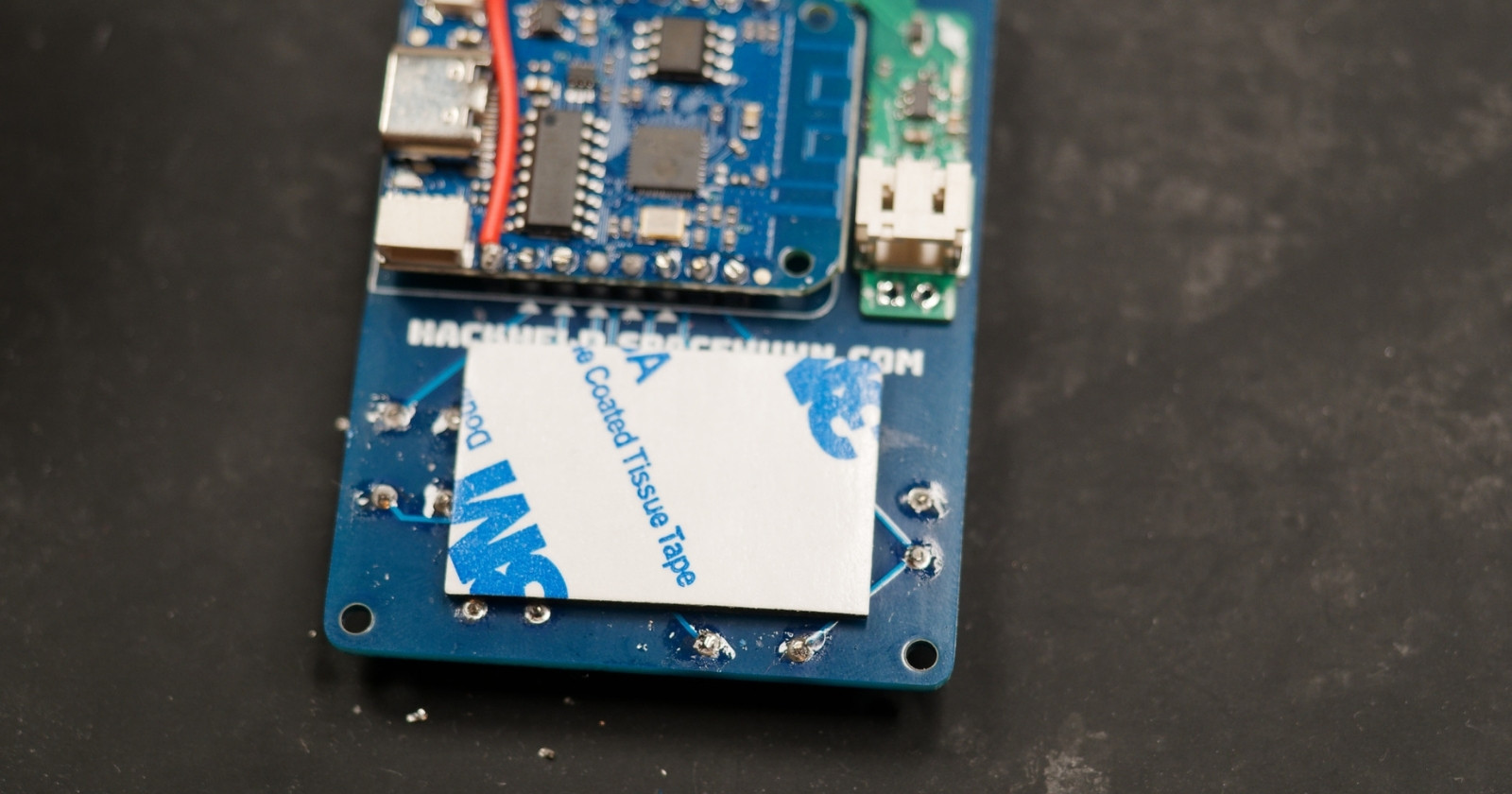 Double sided adhesive placed on HackHeld
