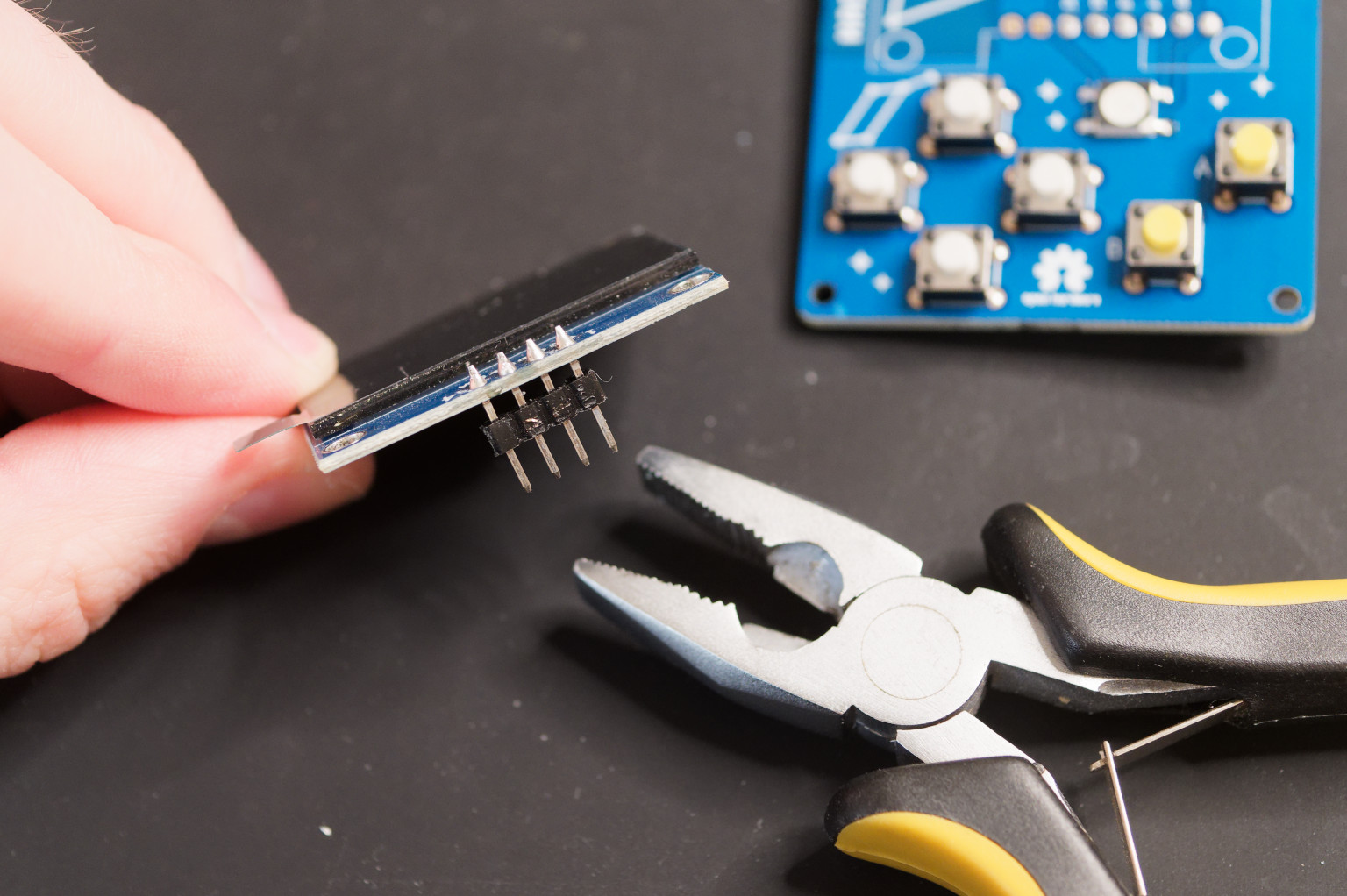Removing plastic part from headers of OLED display