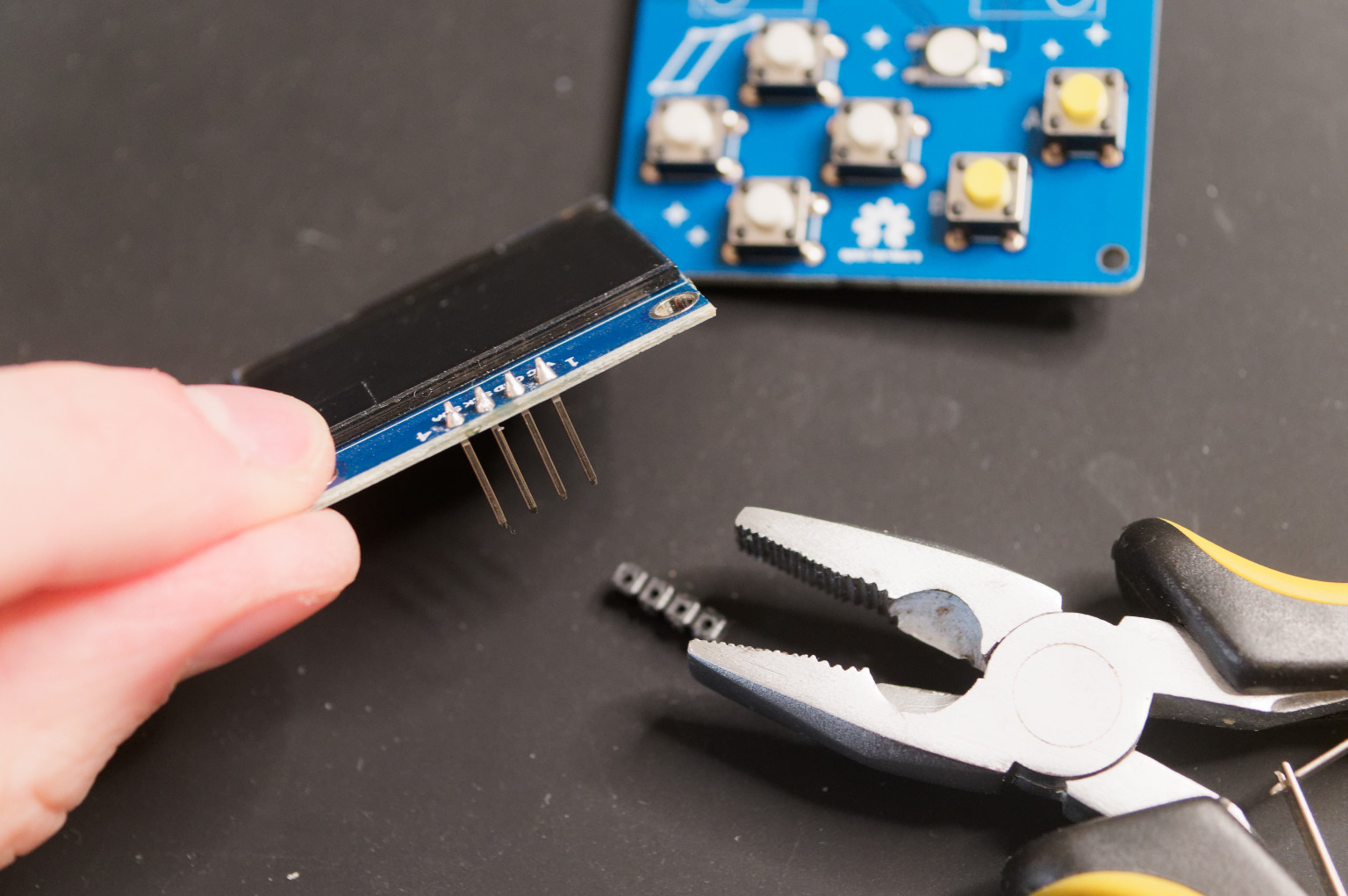 Removing plastic part from headers of OLED display