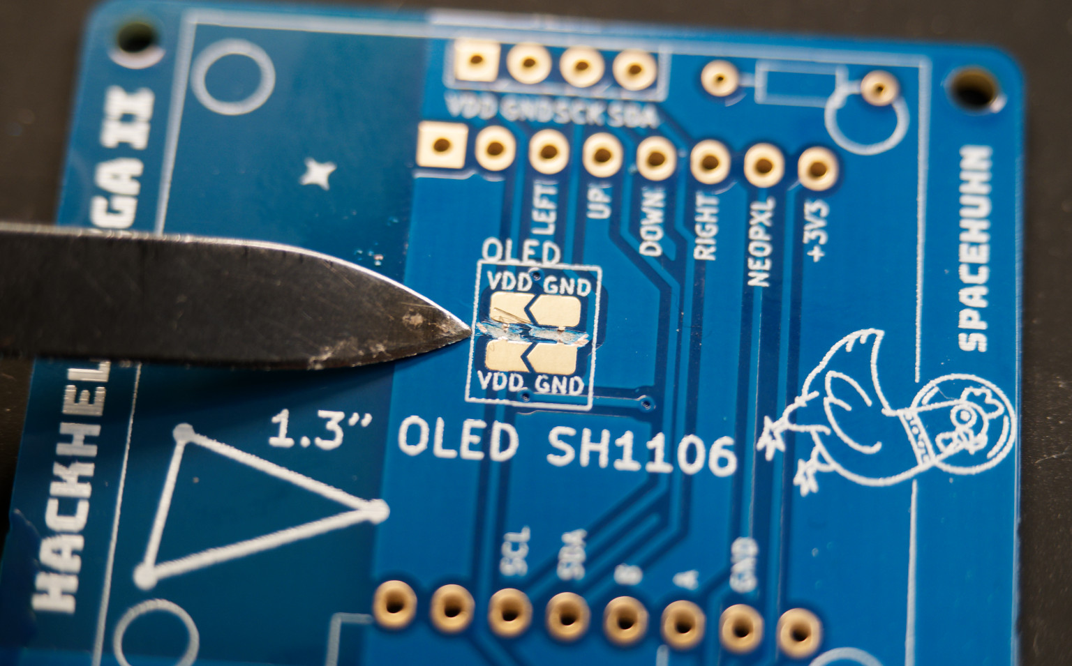 Cutting jumper bridges on HackHeld PCB with a knife